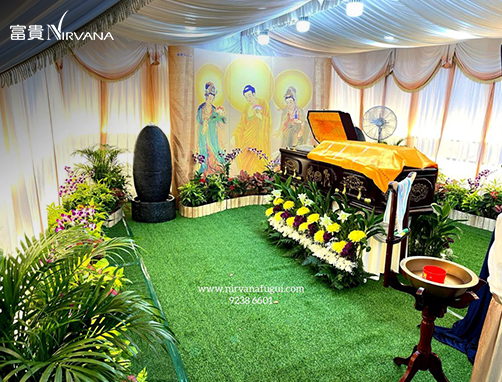 Buddhist funeral held on a grass patch with a golden coffin